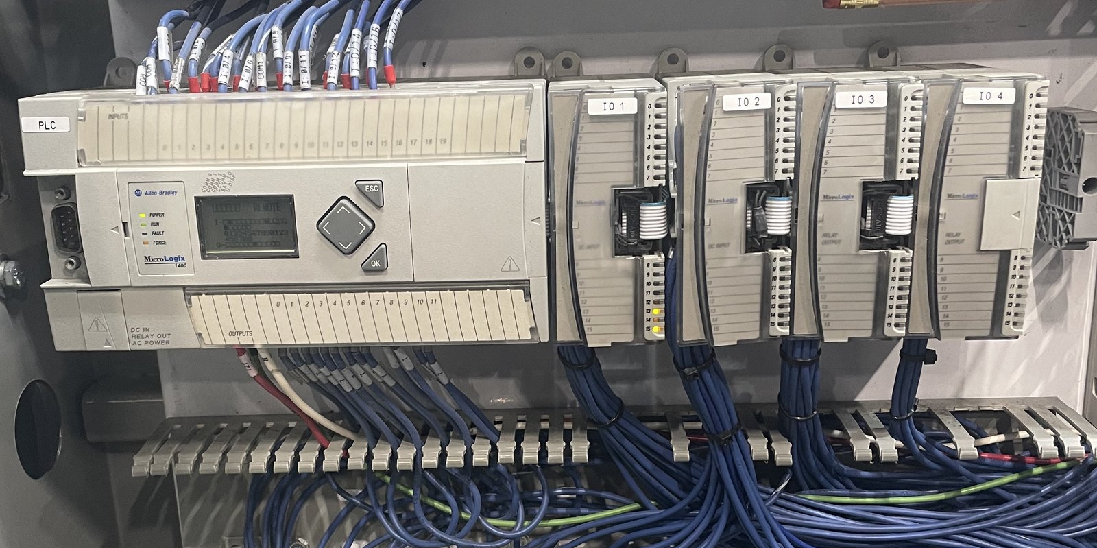 Allen-Bradley MicroLogix 1400 with expansion I/O modules and labeled field wiring.